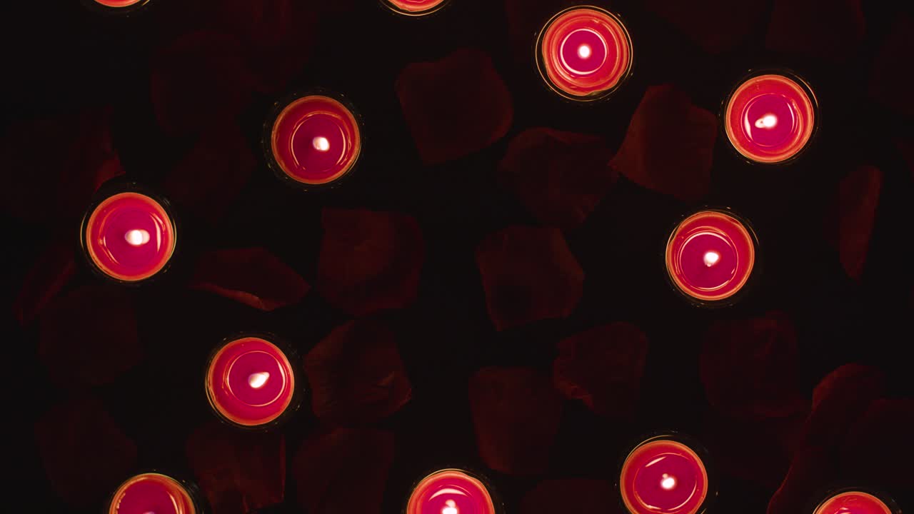Free stock video - Overhead shot of romantic lit red candles on